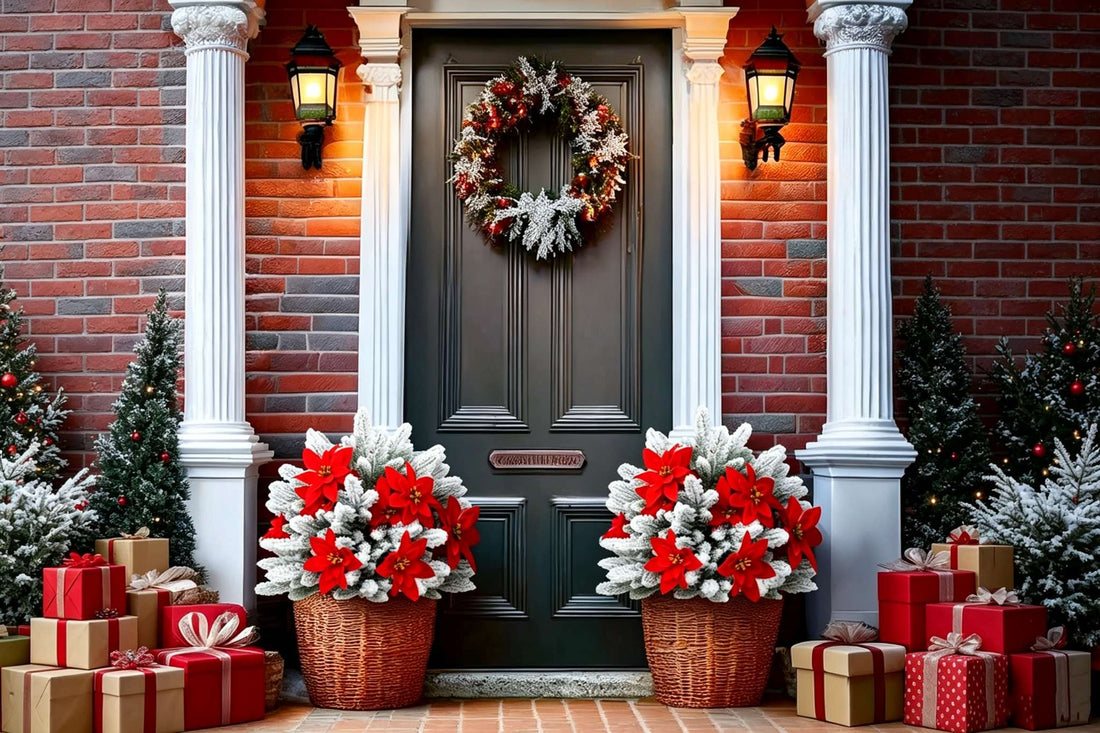 Two artificial snow flocked pine with red poinsettia arrangements in wicker baskets flanking black front door with columns lanterns and gift boxes for luxury christmas decor