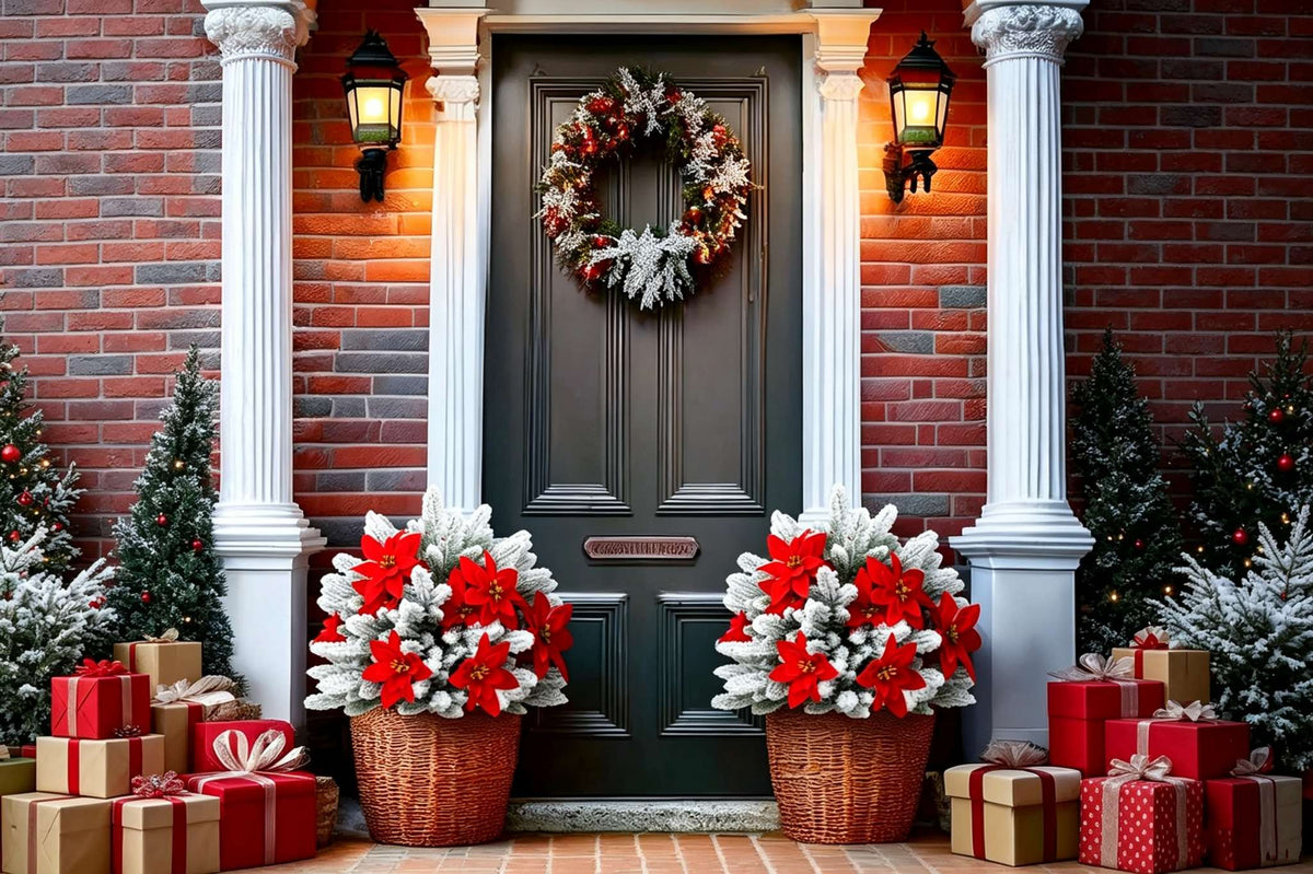 Two artificial snow flocked pine with red poinsettia arrangements in wicker baskets flanking black front door with columns lanterns and gift boxes for luxury christmas decor