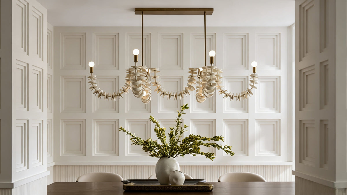 Bright paneled dining room interior, styled table centerpiece with lush green artificial foliage for modern home staging