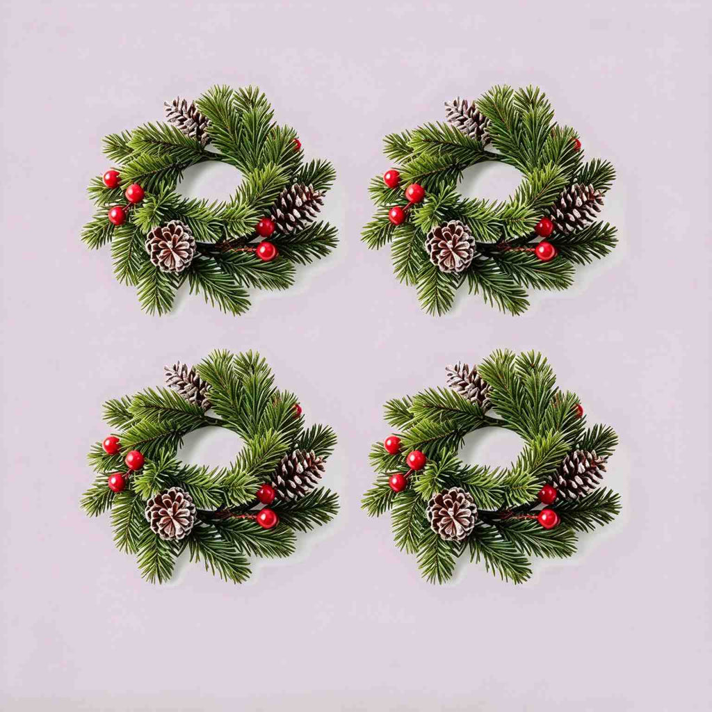 4 pack Christmas pine candle rings with red berries and frosted pinecones, product flat lay on light grey background