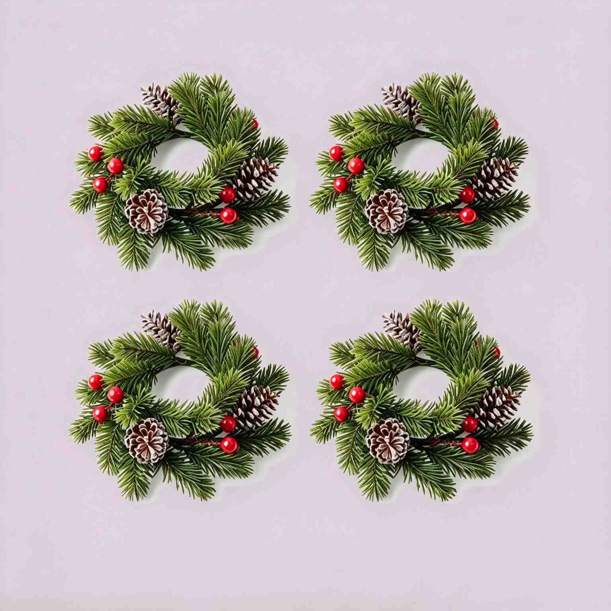 4 pack Christmas pine candle rings with red berries and frosted pinecones, product flat lay on light grey background