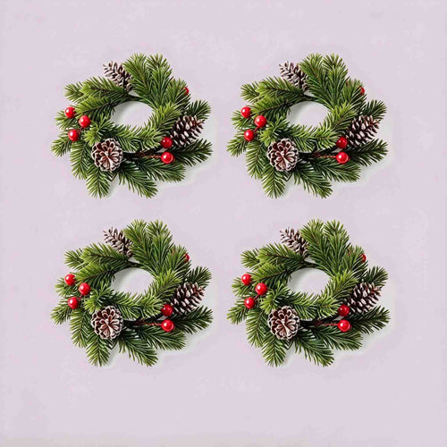 4 pack Christmas pine candle rings with red berries and frosted pinecones, product flat lay on light grey background