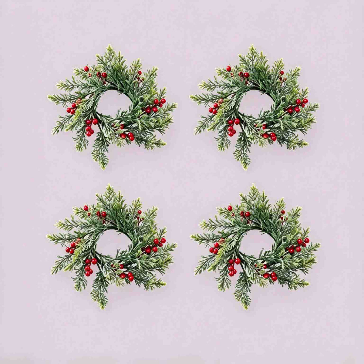 4 pack artificial cypress red berry candle rings, flat lay product display on light grey background for Christmas table decor