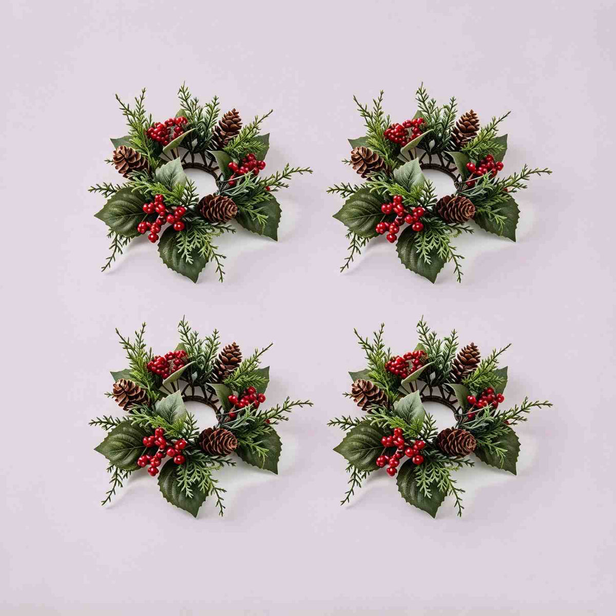 4 pack artificial pinecone red berry Christmas candle rings, flat lay product display on light grey background
