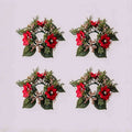 4 pack Christmas poinsettia candle rings with red poinsettia blooms, gold berries and cedar foliage on light grey background