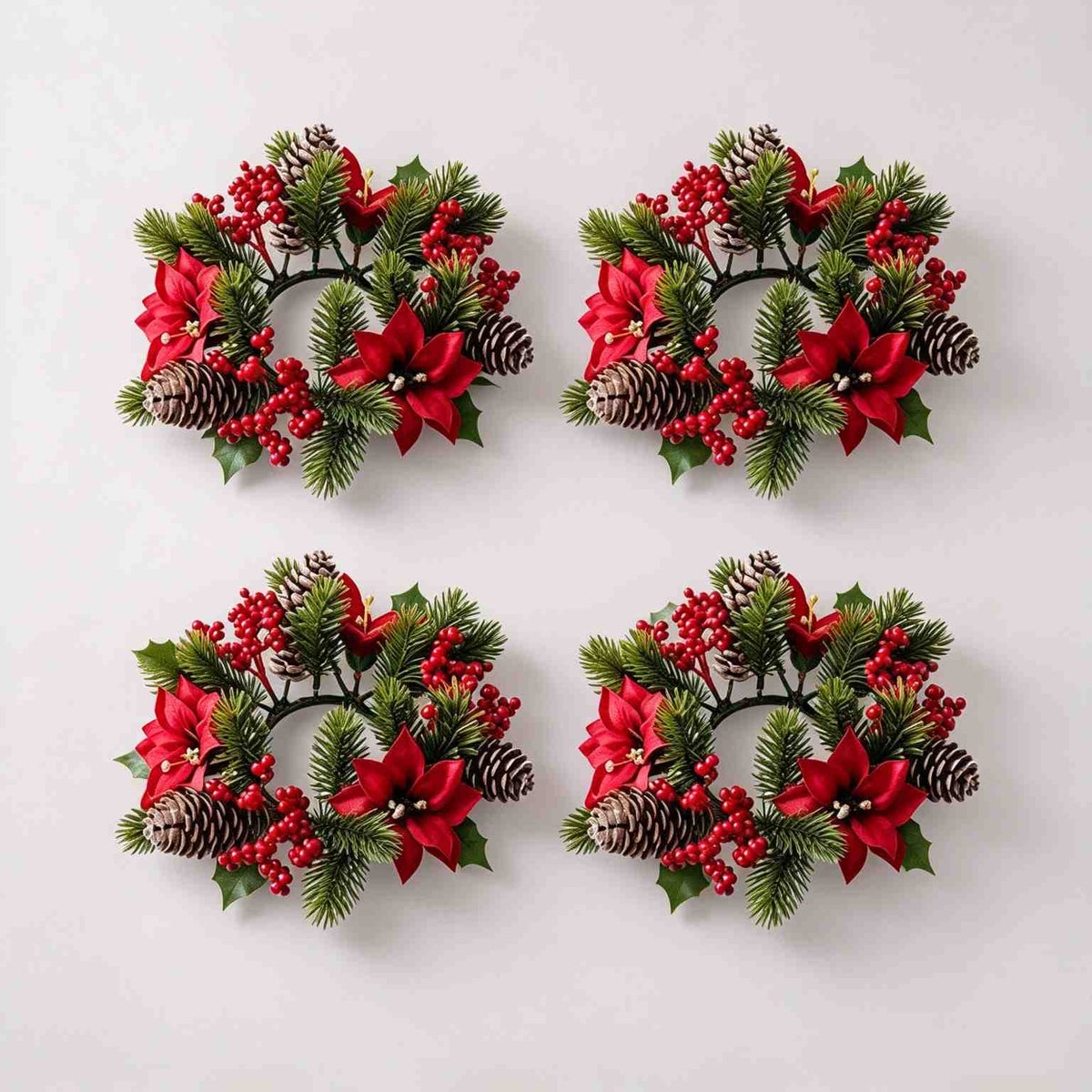 4 pack christmas candle ring wreath with red poinsettia, red berries and frosted pine cones, flat lay product display