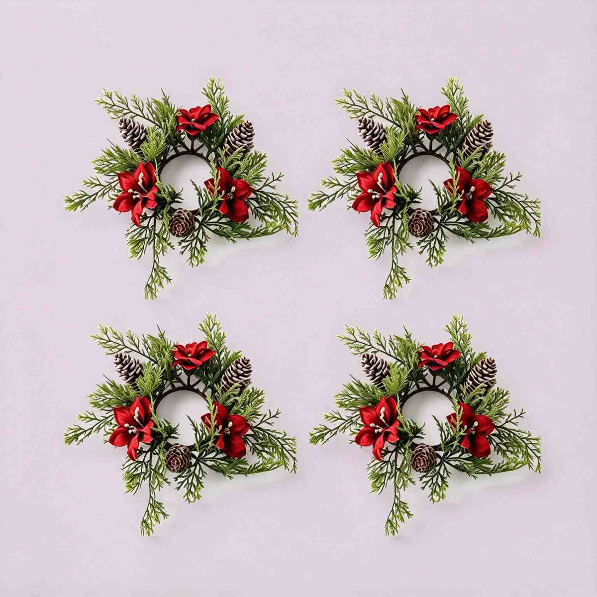 4 pack artificial Christmas candle rings with red poinsettia blooms, frosted pinecones and cypress greenery, product shot on light grey background
