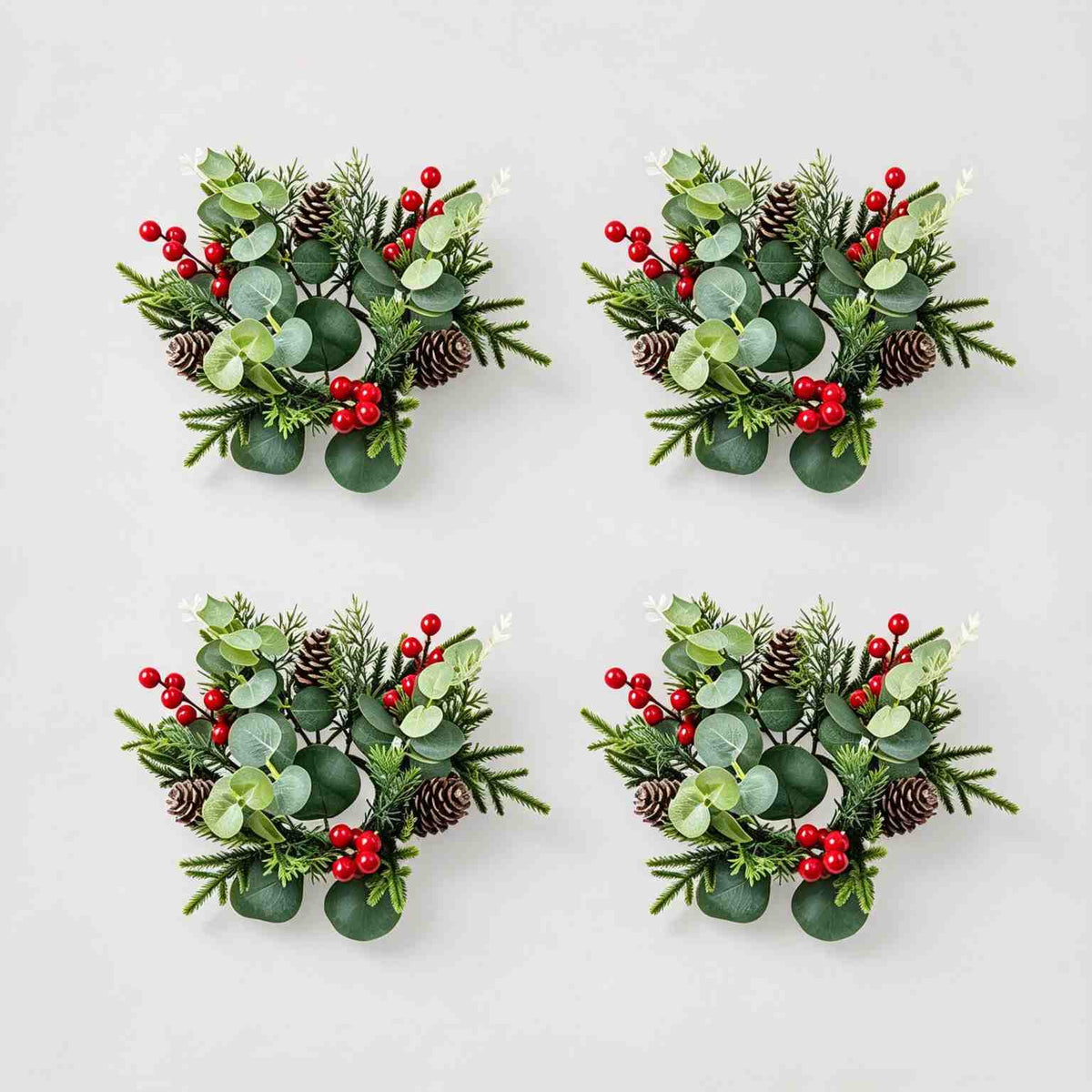 4 pack artificial Christmas candle rings with eucalyptus, pinecones and red berries, product collage on light grey background