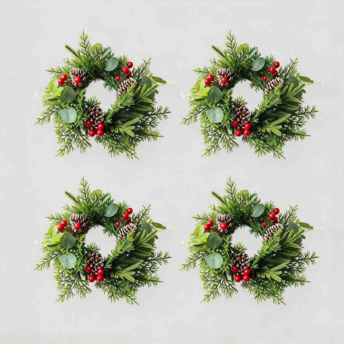 4 pack artificial Christmas candle rings with eucalyptus, pine cones and red berries, product collage on light grey background