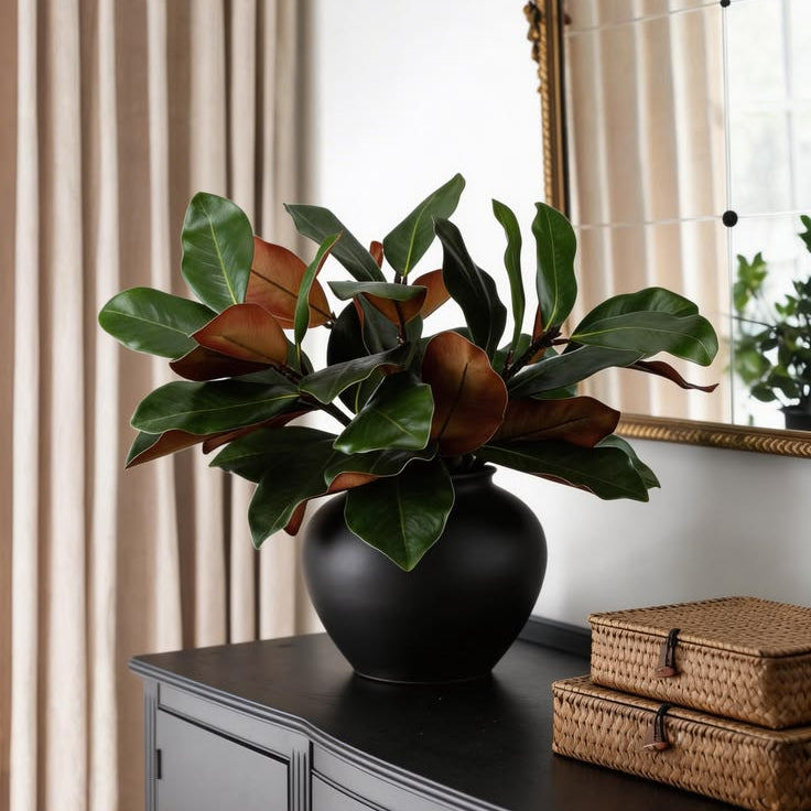 Lush broad magnolia leaf faux plants arrangement with two-tone foliage for vintage curved entry cabinet styling