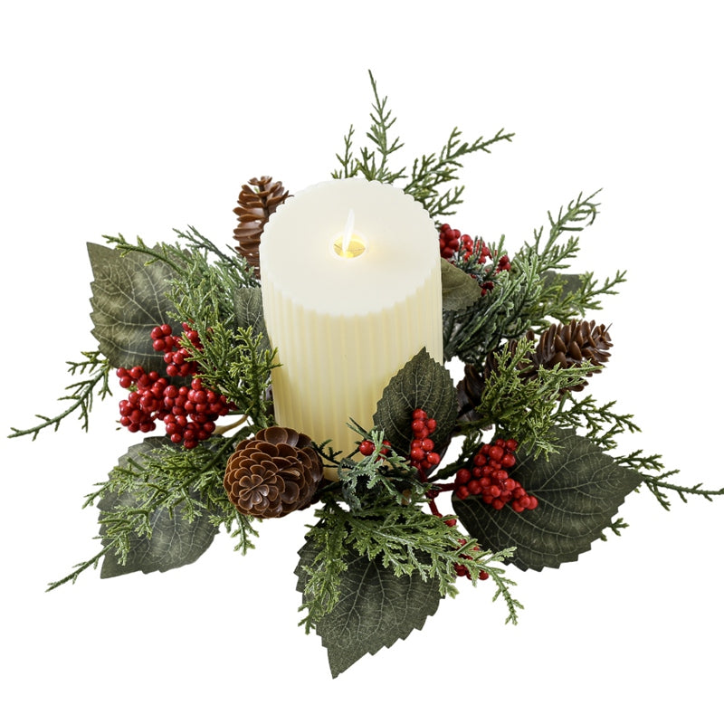 Artificial Christmas candle wreath ring with pinecones, red berries and green foliage surrounding pillar candle on clean white round table