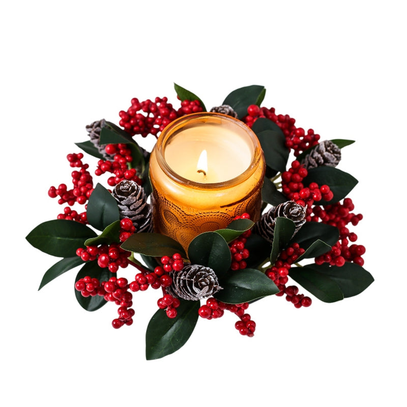 Christmas candle wreath holder with red berries green leaves pine cones around amber jar candle, isolated white background product photo