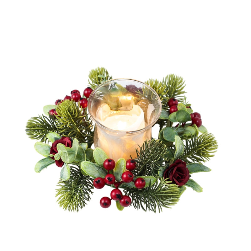 Christmas candle ring with red berries, burgundy roses, eucalyptus and pine greenery encircling glass candle, isolated white product photo