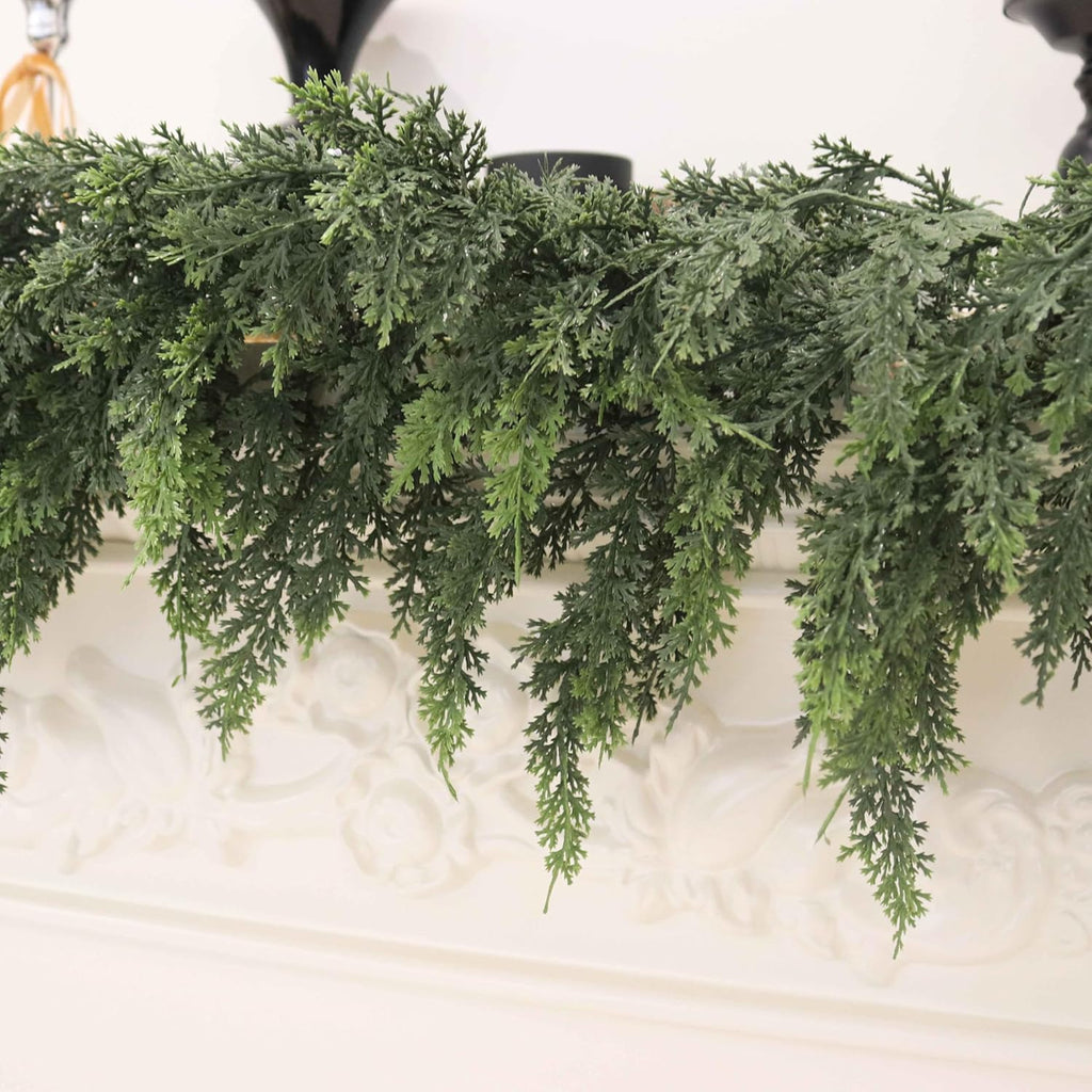 Close up realistic layered cedar foliage christmas garlands hanging on carved white mantel texture display