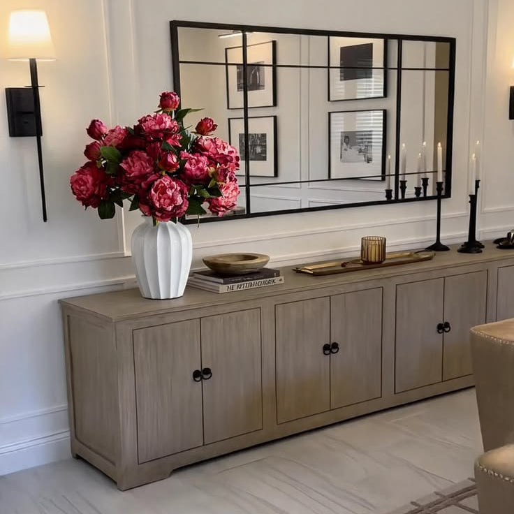 Abundant dark pink peony faux flowers bouquet paired with ribbed white vase for neutral hallway cabinet display