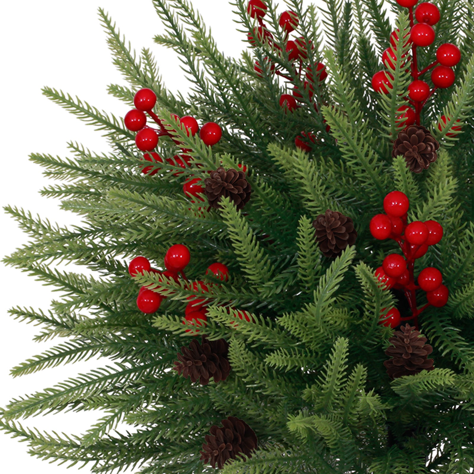 Closeup mini christmas tree lifelike pine sprigs accented with glossy red berries and dark pinecones
