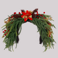 Dense drooping pine green wreath flexible arch shape decorated with poinsettia, berries & natural pinecones