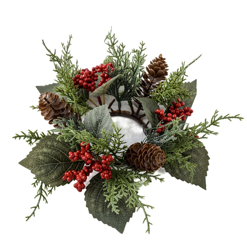 Empty Christmas candle ring made of artificial cypress, red berries, pine cones and green leaves, top view white background