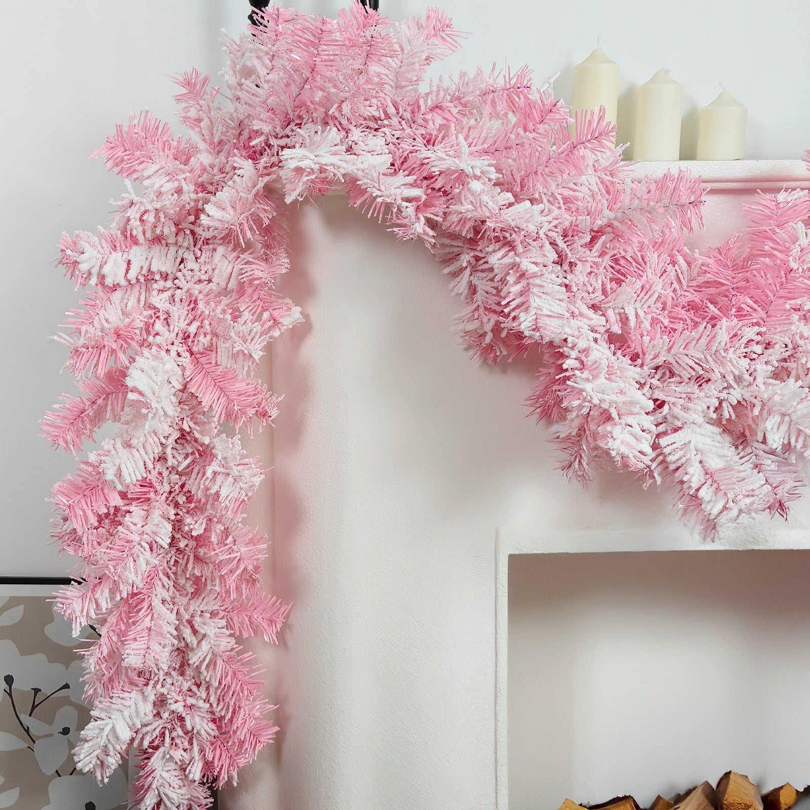 Flushed flocked pink white pine faux xmas garland draped over white fireplace mantel girly winter home decor