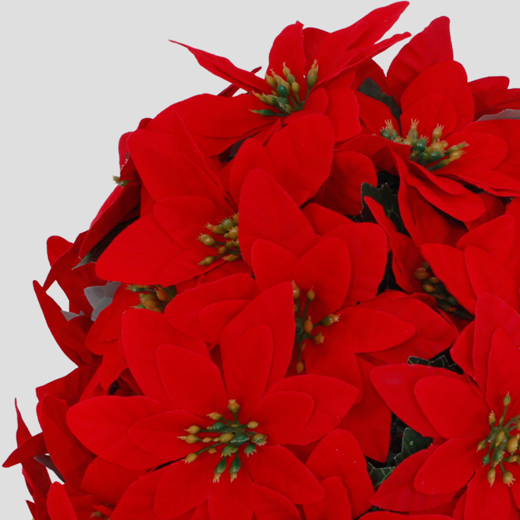 Closeup soft fabric red poinsettia artificial tree indoor tabletop fireplace pot decoration