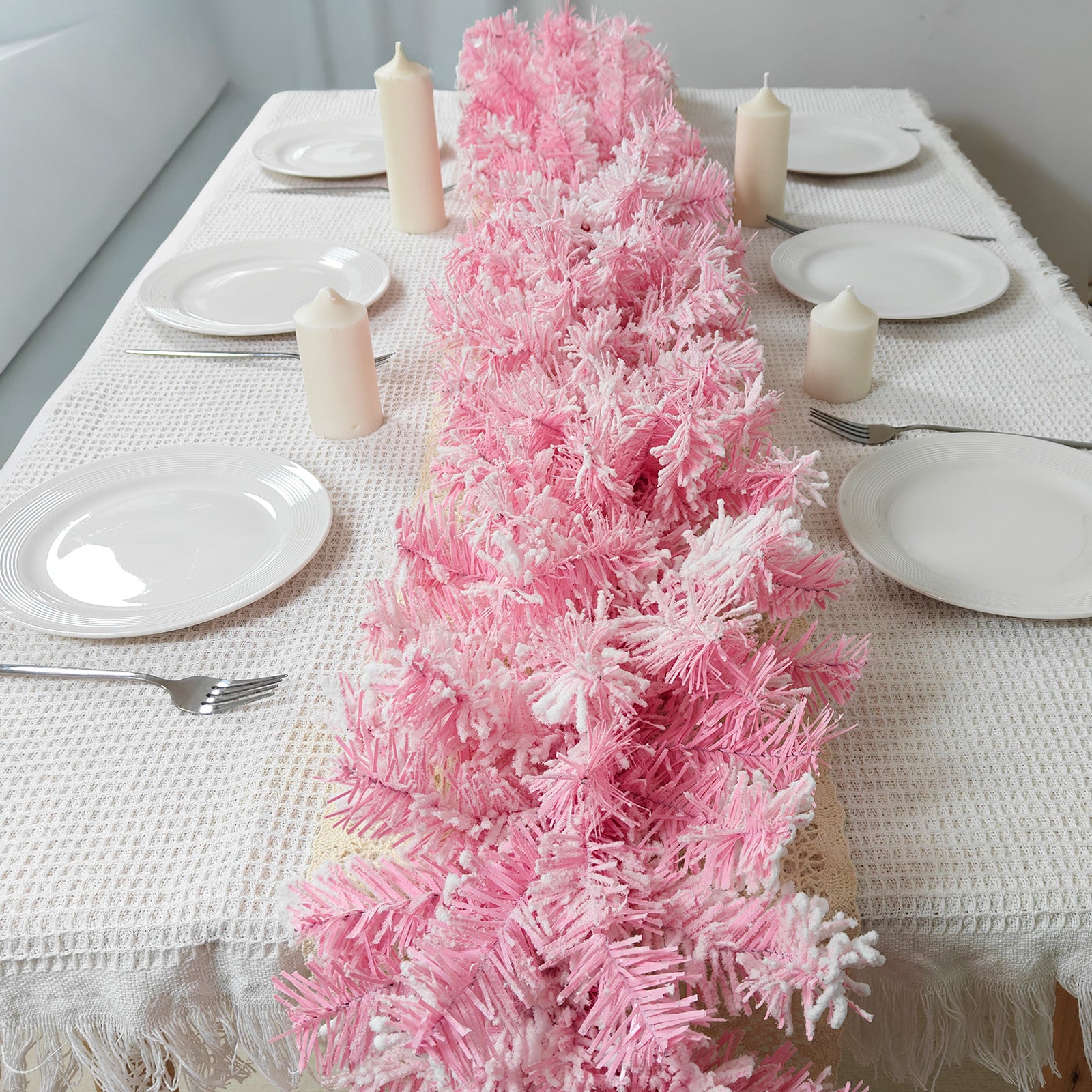 Full length fluffy flocked pink pine artificial christmas garland complete white dining table festive setup