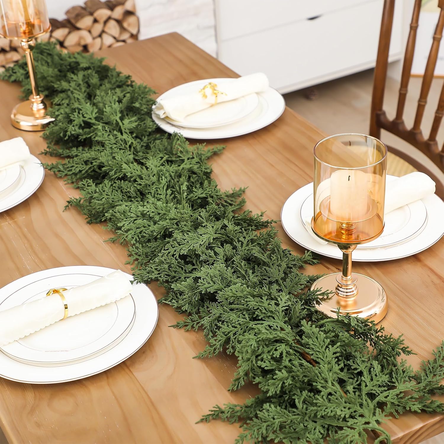 Long minimalist cedar artificial christmas garland table runner matched with gold candle holders elegant holiday dinner decor