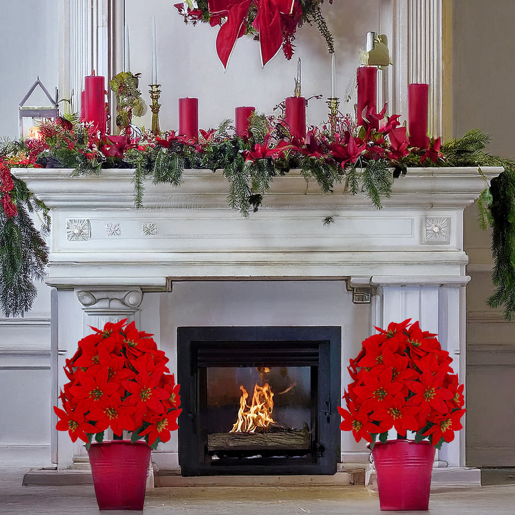 Matching set of dense poinsettia christmas trees for symmetrical indoor fireplace festive styling