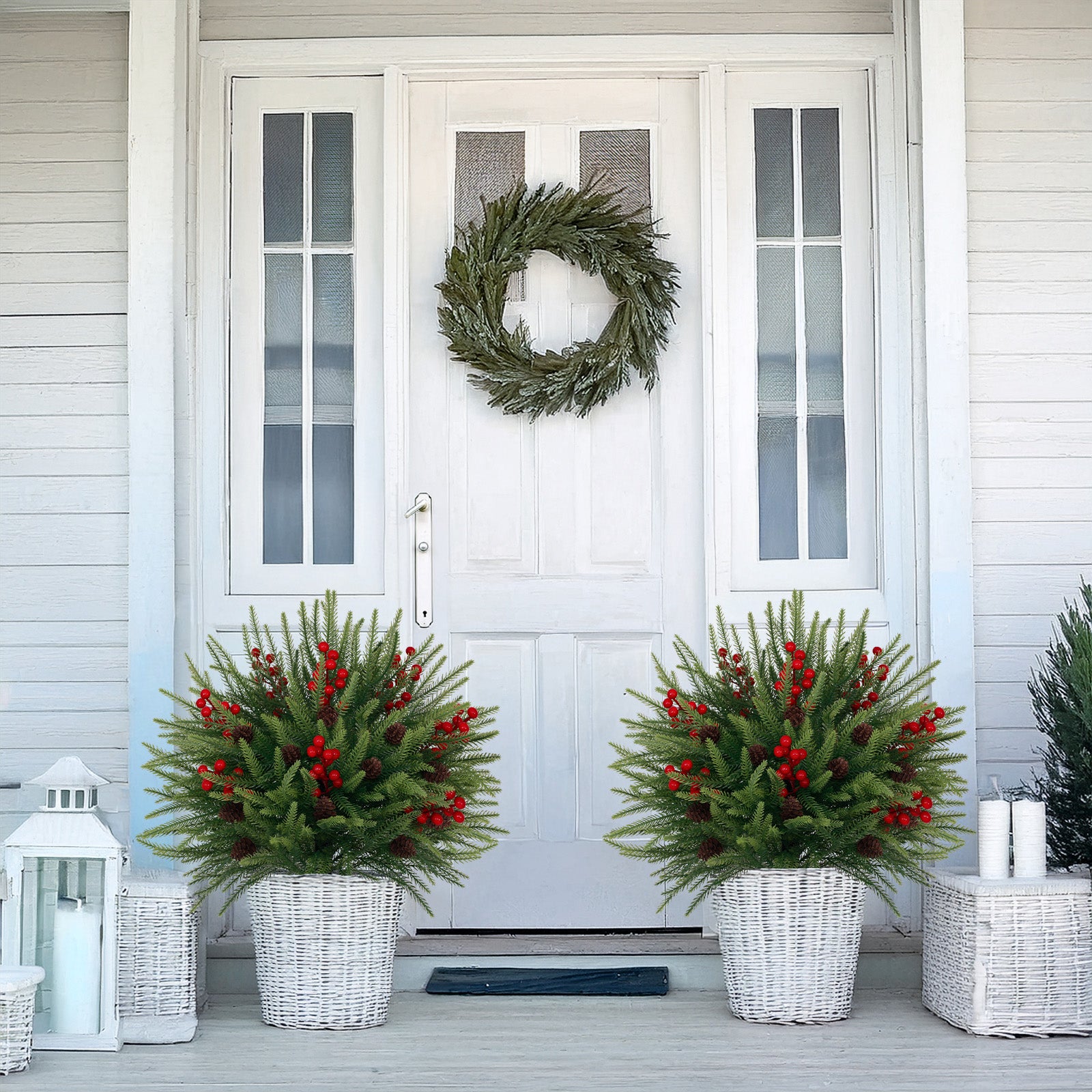 Matching symmetrical artificial christmas trees with red berries for farmhouse entryway festive styling