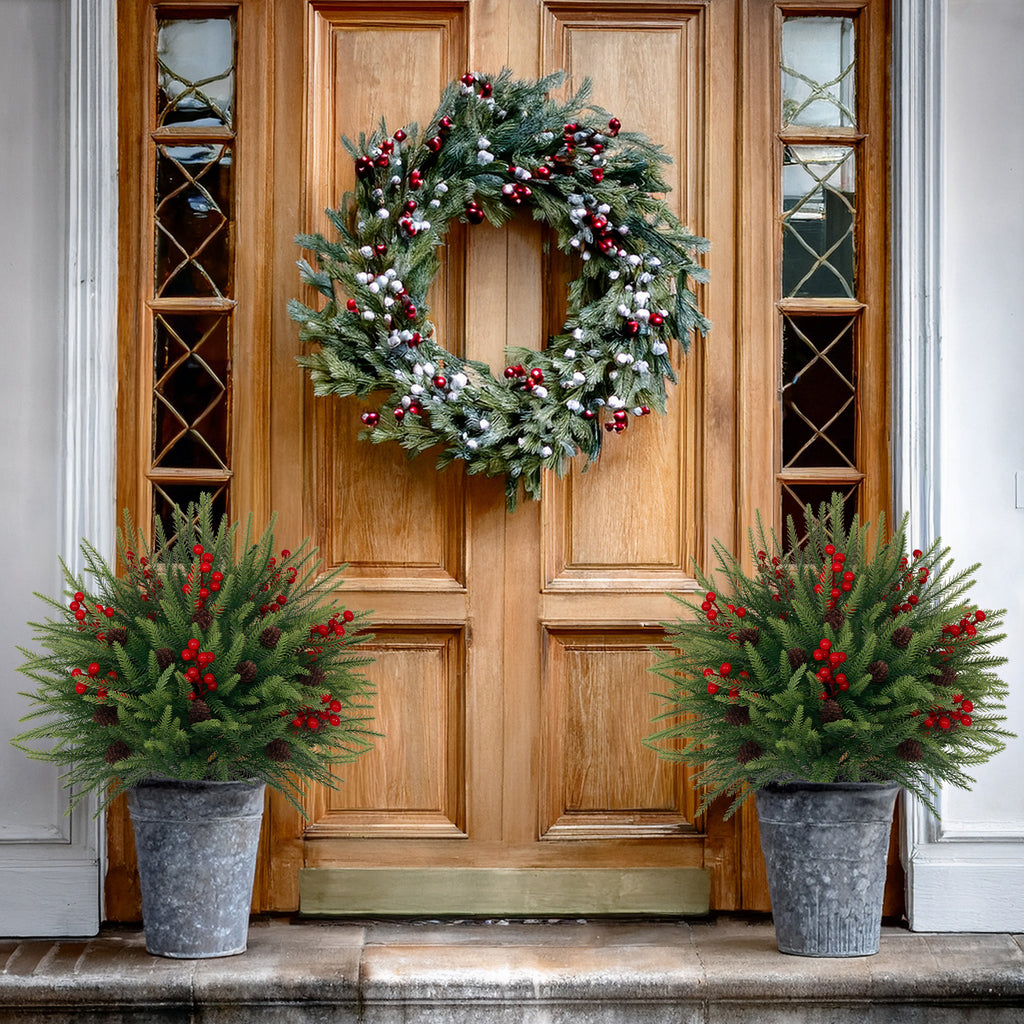 Textured layered pine artificial trees with abundant red berry clusters and natural pinecone accents