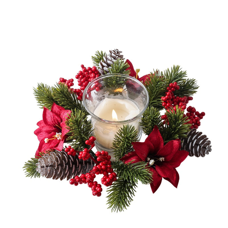 Small christmas candle ring wreath with red poinsettia flowers, berries, pine cones and pine sprigs, isolated white background product shot