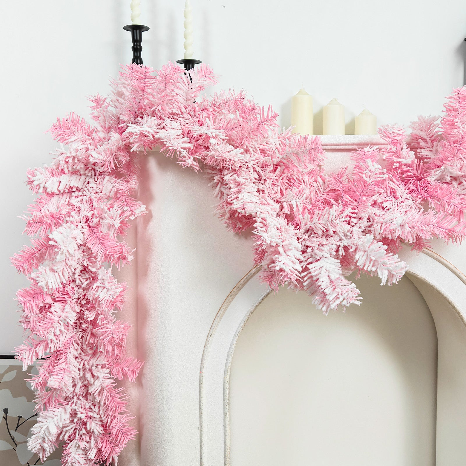 Flushed flocked pink white pine faux xmas garland draped over white fireplace mantel girly winter home decor