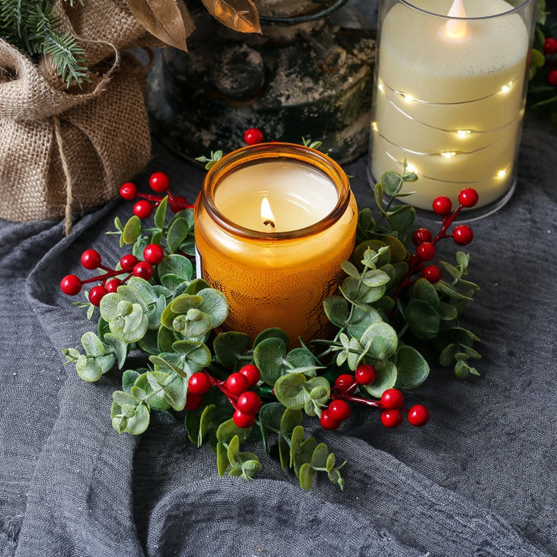 Artificial eucalyptus red berry candle ring paired with amber candle, cozy winter farmhouse table decoration